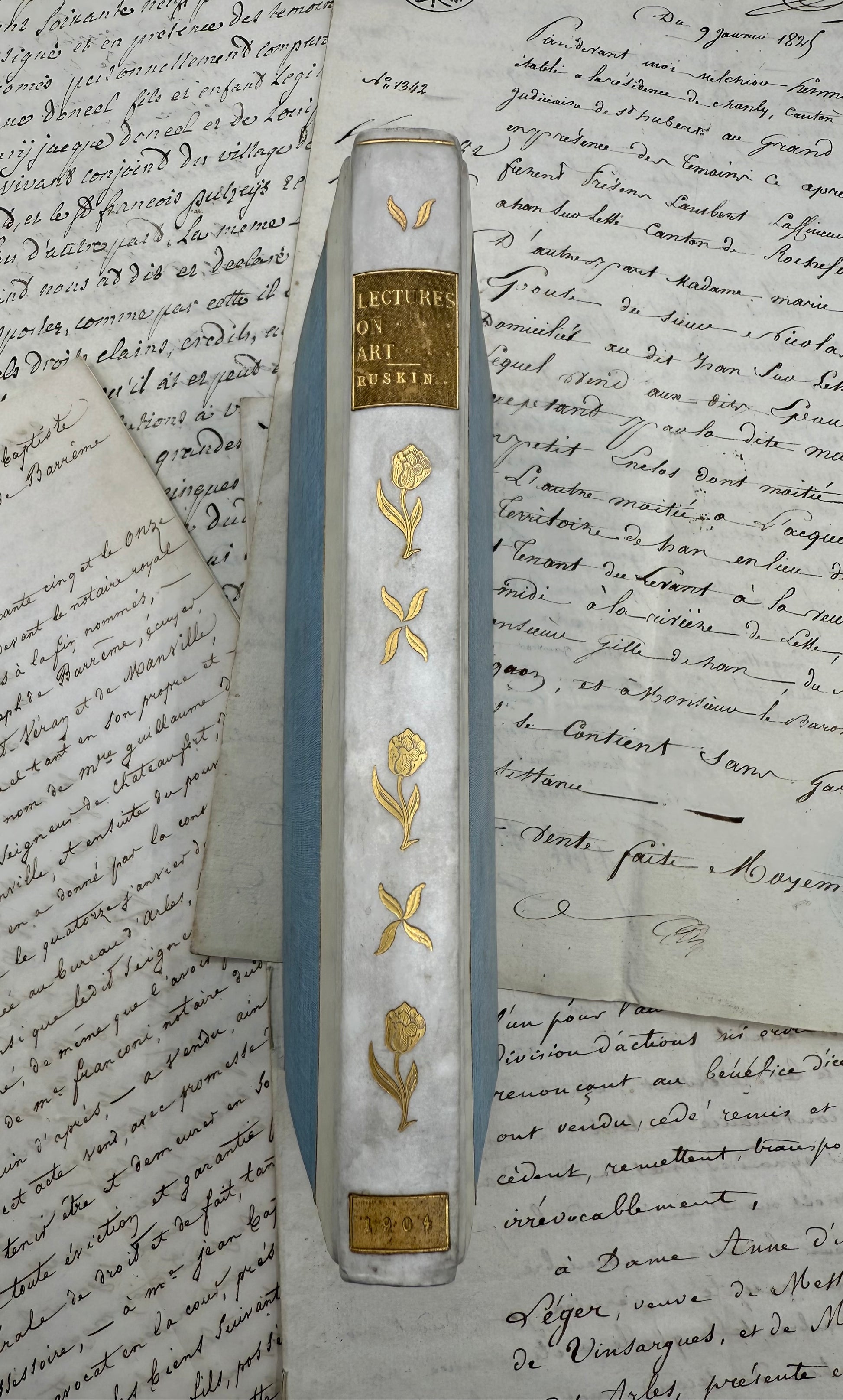 Decorative pen with gold floral designs on a piece of handwritten text