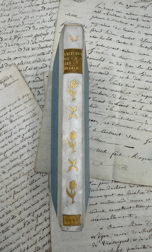 Decorative pen with gold floral designs on a piece of handwritten text