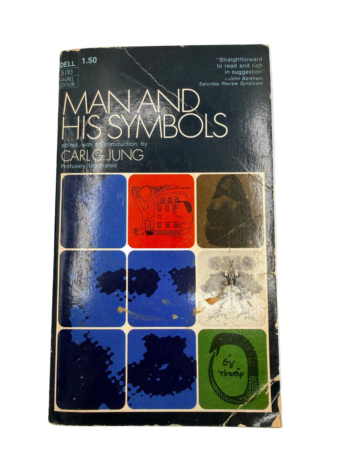 A vintage paperback book of Carl G. Jung's 'Man and His Symbols' on a light off-white background.
