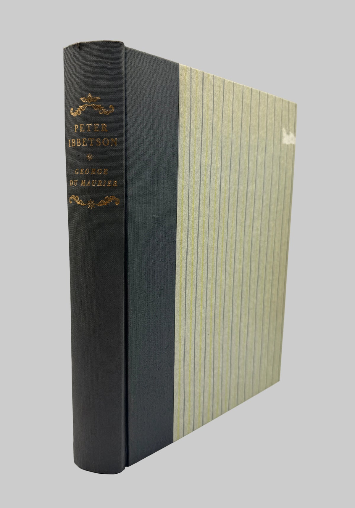 A vintage hardcover book standing upright, showing a dark charcoal-gray cloth spine with gold lettering and a matching striped cover in beige and gray-green tones.
