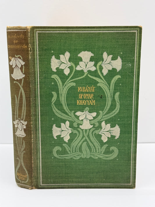 An antique hardcover book titled 'Rumƣơt al-Qurān al-Khayyam' featuring a green linen cover with white floral illustrations and gold lettering, shown standing upright against a plain white background.