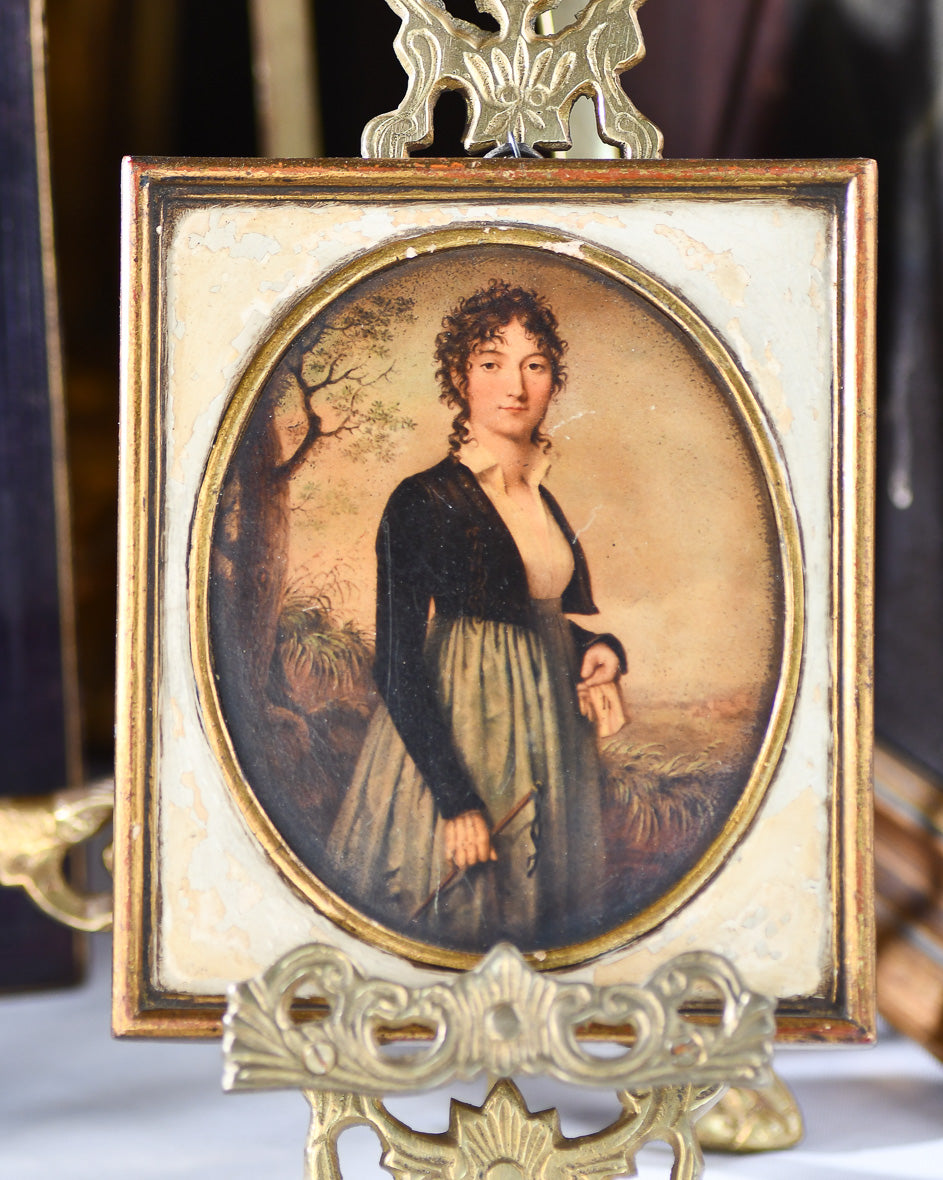 Vintage portrait of a woman in a decorative frame on a stand