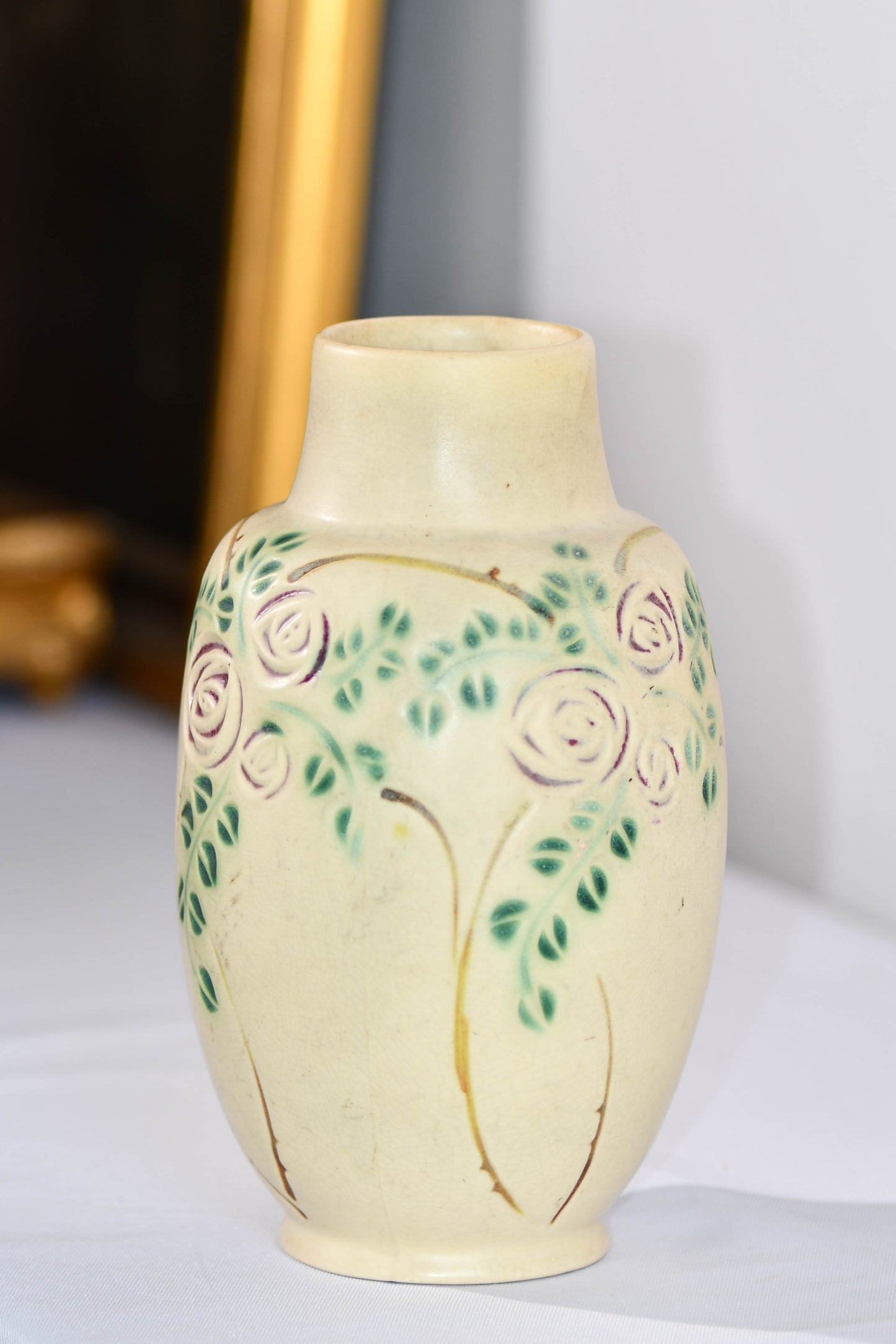 Decorative ceramic vase with floral patterns on a plain background