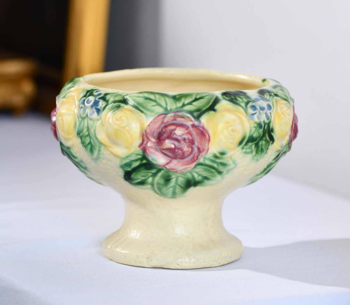 Ceramic egg cup with floral design on a white surface