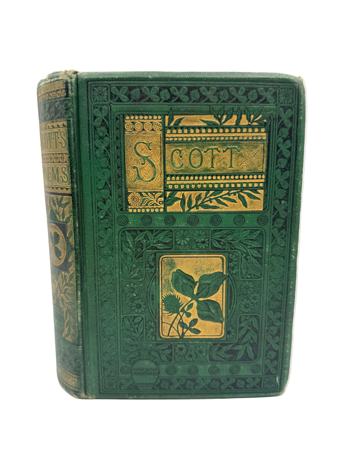 An antique hardcover book with a dark green embossed cover and gold decorative panels, standing upright against a plain white background.