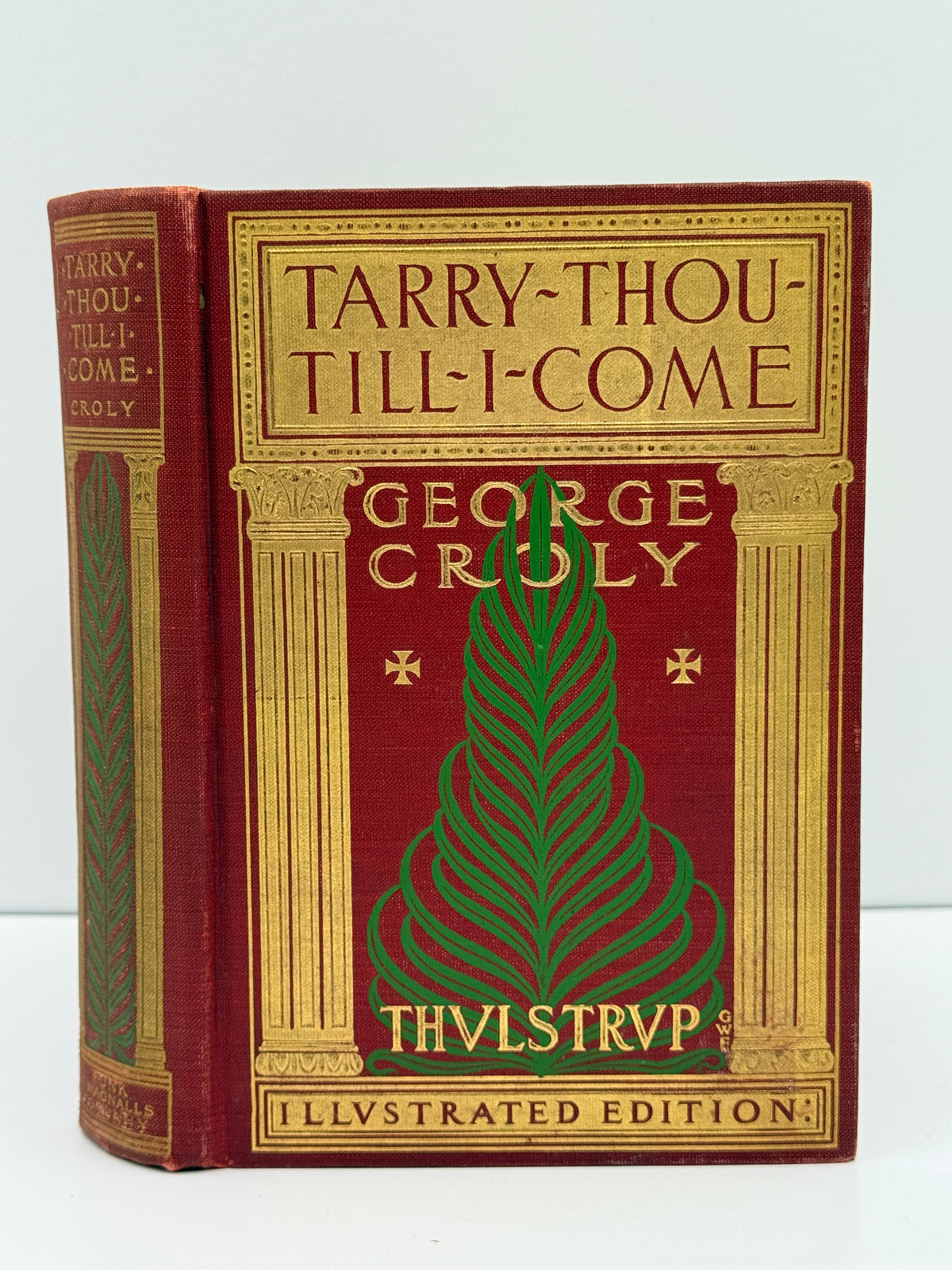 A vintage hardcover book titled 'Tarry-Thou-Till-I-Come' by George Crioly, featuring a deep red cover with ornate gold lettering, decorative columns, and a green stylized leaf design on the front cover.