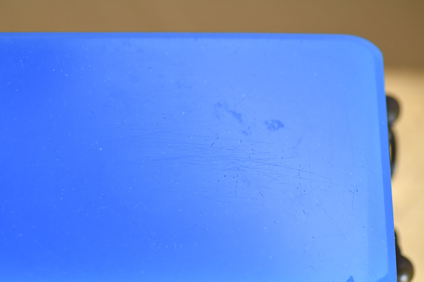 A surface scratch on a blue opaline glass box