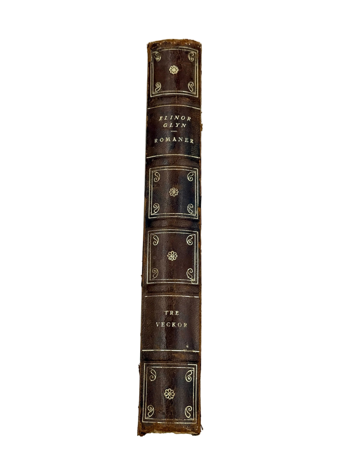 The spine of a vintage leather-bound book titled 'The Heckle' by Elwin Glyn Bowman, featuring dark brown leather with gold gilding and lettering, photographed vertically against a plain white background.