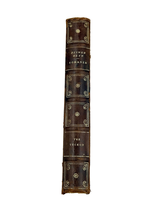 The spine of a vintage leather-bound book titled 'The Heckle' by Elwin Glyn Bowman, featuring dark brown leather with gold gilding and lettering, photographed vertically against a plain white background.