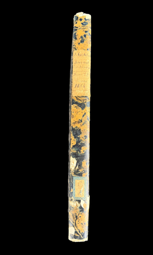 Vintage book with yellowed pages on a dark surface