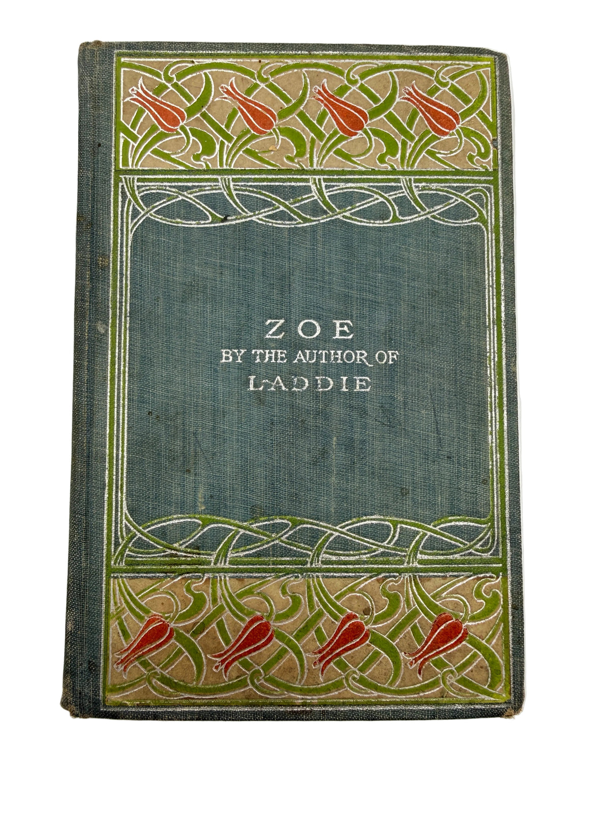an antique book with a blue cover and red flowers