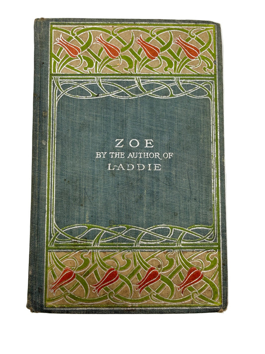 an antique book with a blue cover and red flowers
