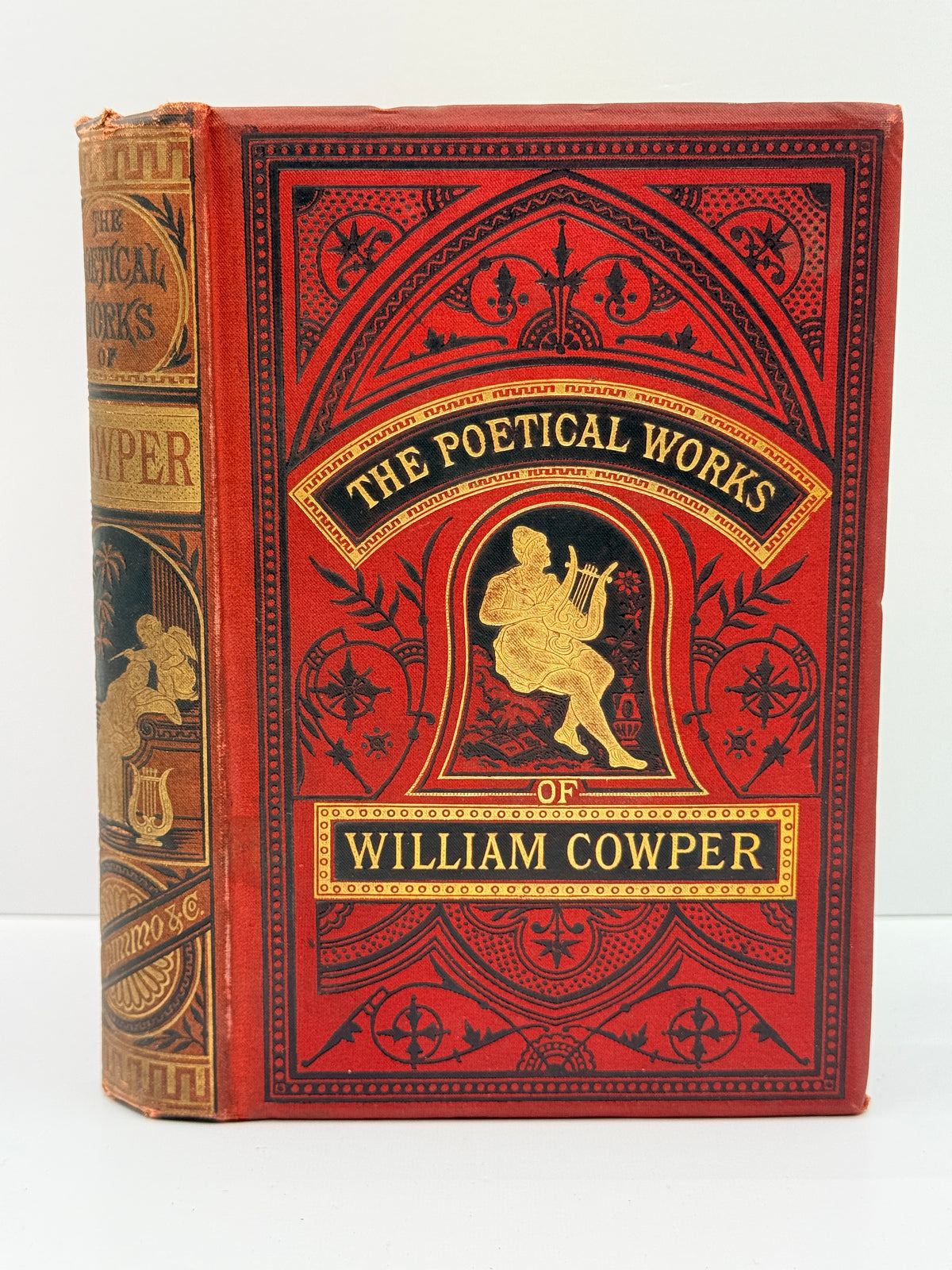 A vintage hardcover book titled 'The Poetical Works of William Cowper' with ornate red and black decorative cover and gold lettering, photographed upright against a plain light background.