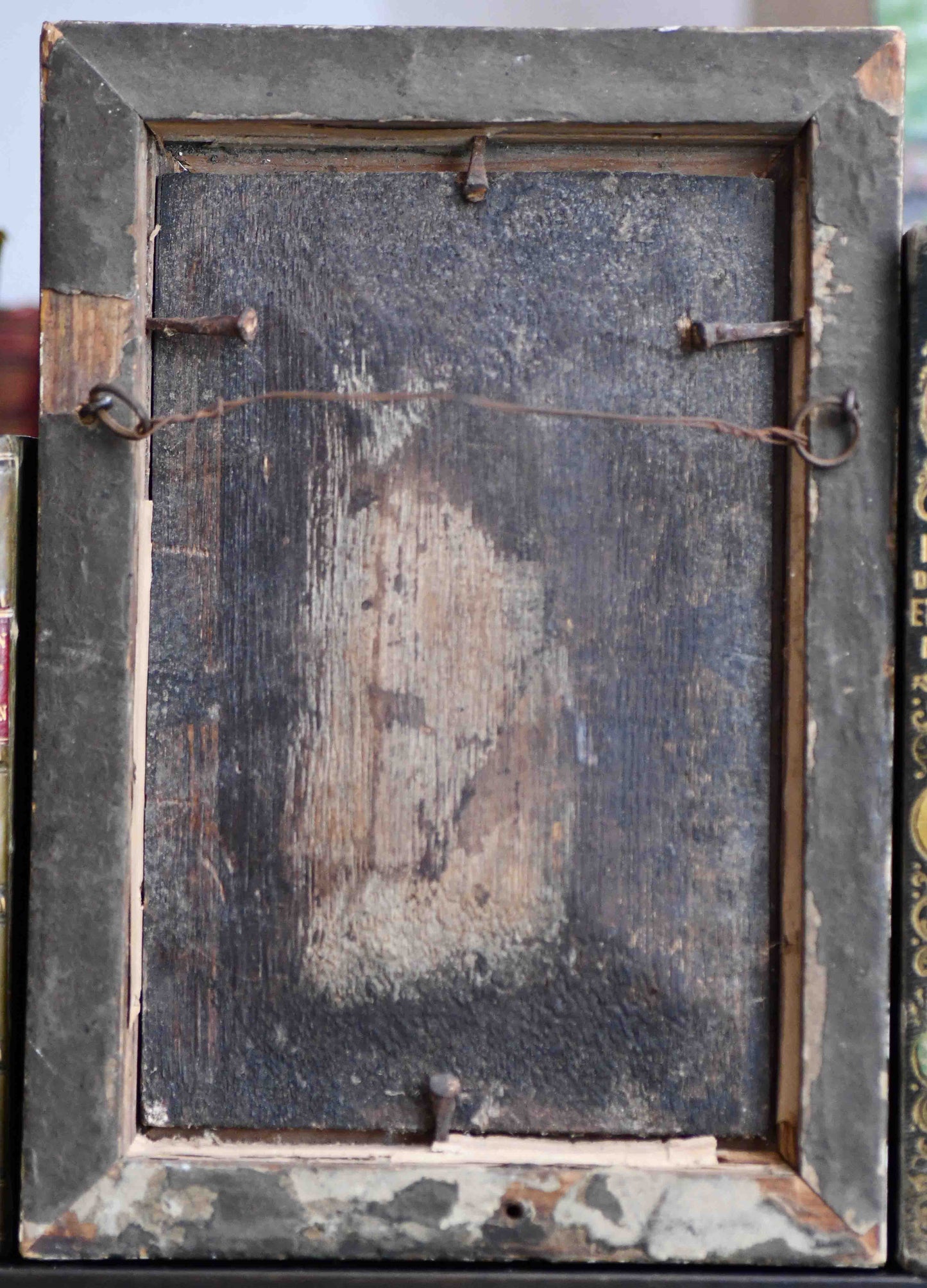 Vintage wooden picture frame with peeling paint and metal hardware