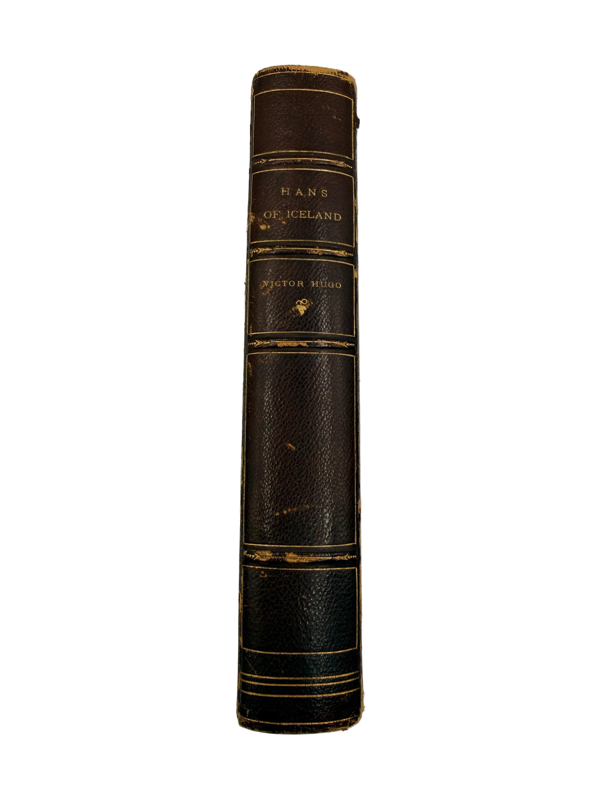 A vintage hardcover book standing upright, showing its dark brown leather-bound spine with gold lettering that reads 'HANS GERMELAND' and 'Winston Millar'.
