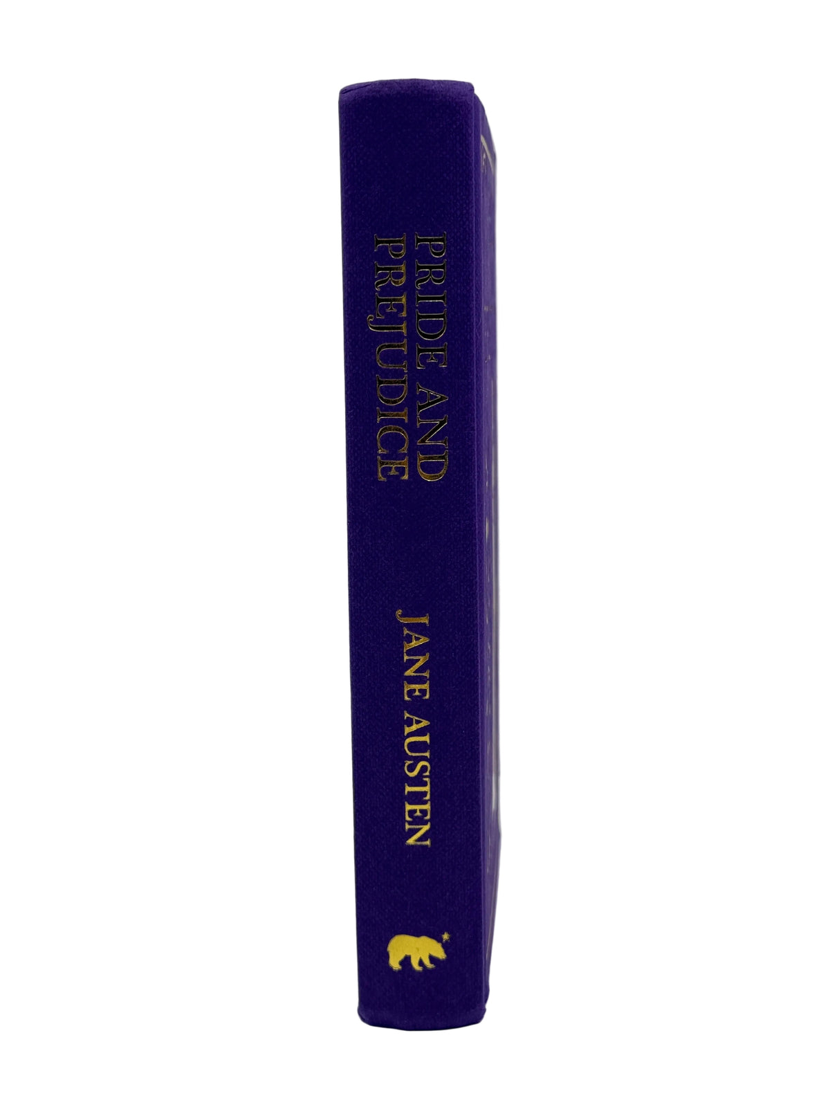 A hardcover book standing upright, showing its purple spine with gold lettering that reads 'PRIDE AND PREJUDICE' and 'JANE AUSTEN,' plus a small gold bear logo near the bottom.