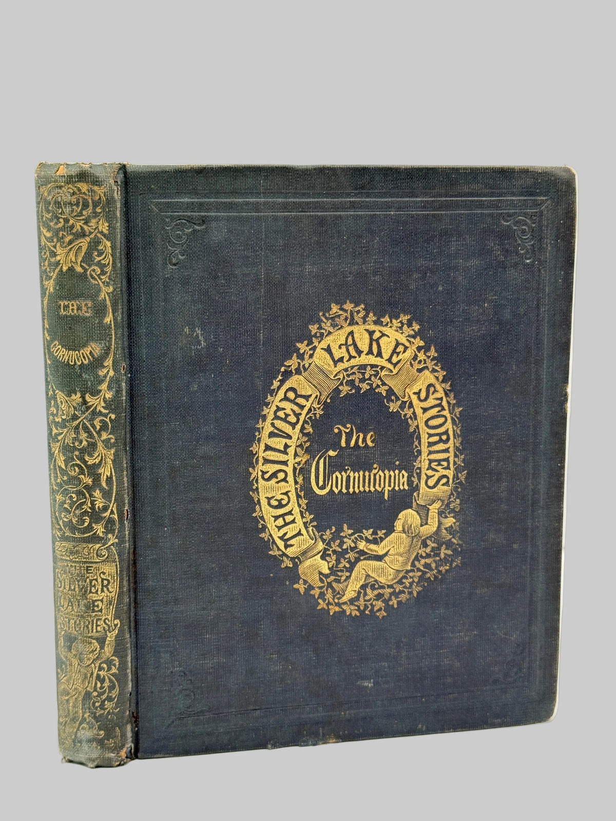 An antique hardcover book titled 'The Silver Lake Stories' with a dark blue-gray cloth cover and ornate gold foil detailing on the front cover and spine.