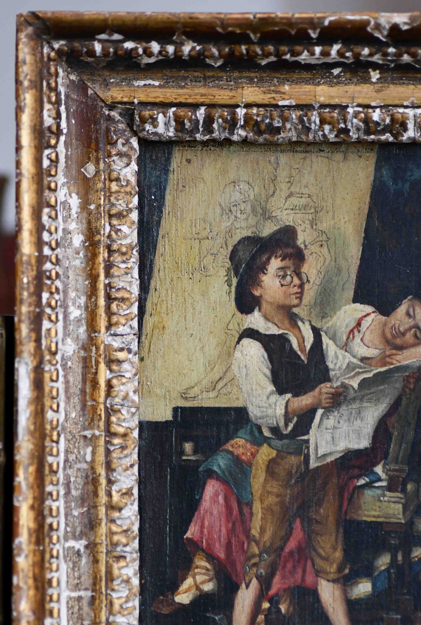 Old painting of a man and woman in a decorative frame