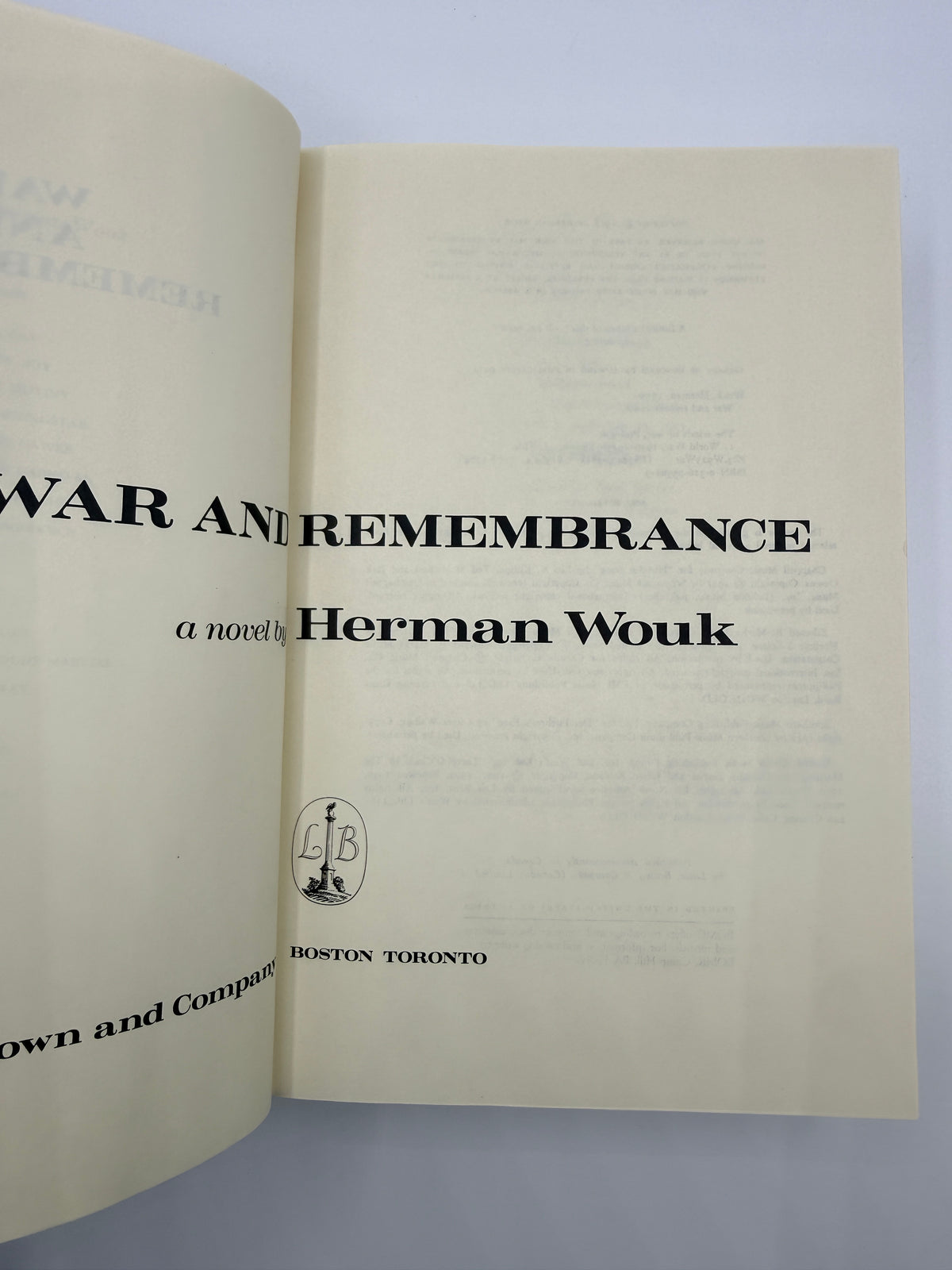 An open book showing the title page of 'War and Remembrance' by Herman Wouk, printed in black on aged cream paper against a light gray background.