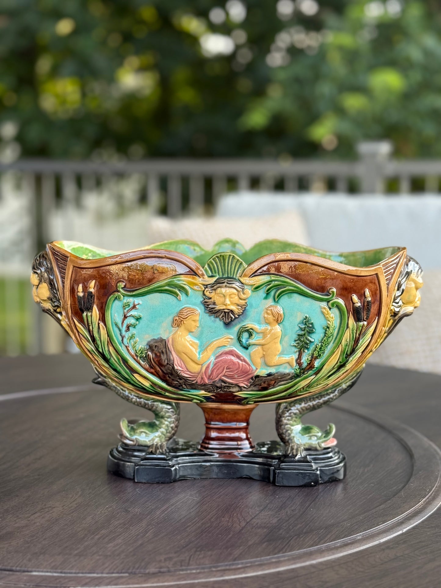 Decorative ceramic bowl with artistic designs on a wooden surface